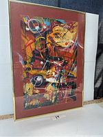 Full image of the framed abstract art piece with red mat and gold frame