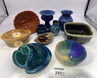 Front view of all nine MCM pottery pieces including bowls, ashtrays, vases, and decorative containers arranged on a white surface.