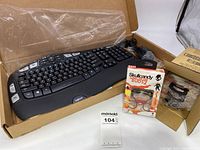 Photo showing Logitech keyboard and mouse in box along with four packaged Skullcandy earbuds