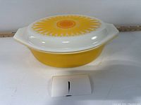Side view of yellow Pyrex casserole with lid on