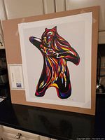 Photo showing the full lithograph print of 'Bear Spirit' by Don Chase, mounted temporarily on cardboard for display.
