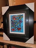 Framed fine art print showing the full artwork and frame in protective corner guards.