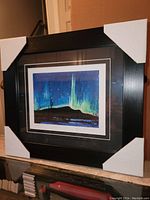 Full front view of the professionally framed Tom Thomson print with protective corner covers.