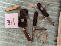 Overview photo showing all 7 knives and multi-tool cutters on fabric background