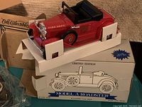 Red Model A Roadster die-cast lockable coin bank in packaging with box labeled 'Model A Roadster Limited Edition'