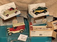 Overview of all three die-cast collectible vehicles with packaging and plastic trays shown.
