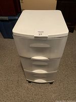 Front view of the plastic storage unit showing the three drawers and clean top surface.