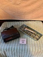 Vintage GE FM/AM clock radio and vintage ice cube maker tray displayed on a fabric surface with a MacSold lot tag visible.