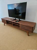 Front view of entire entertainment stand with TV on top