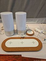 Ikea Nordmarke wireless charging pad with cork border and three charging zones, smaller round charger, and white power adapter cables.