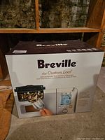 Breville bread maker in unopened box featuring automatic fruit and nut dispenser.