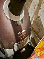 Close-up of front of Miele S2 Special Edition vacuum showing brand, model, power rating, and 'Made in Germany' label
