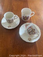 Two King George VI & Elizabeth cups with two saucers and one Sovereign Canada mug shown from top