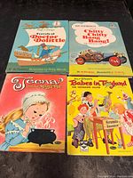 Photo showing four 1960s children's books with illustrated hardcovers: Doctor Dolittle, Chitty Chitty Bang Bang, Jeena and the Magic Pot, Babes in Toyland.