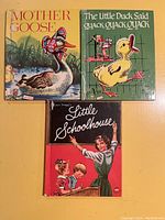Photo of three children's books: Mother Goose, The Little Duck Said Quack Quack Quack, and Little Schoolhouse