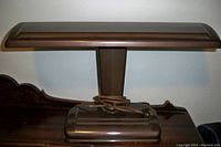 Pair of brown fluorescent desk lamps on a wooden surface, showing overall condition and design.