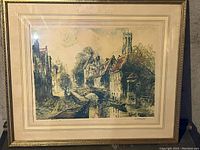 Framed artwork depicting a London-looking street with castle-like home on the right side, in good condition with a vintage feel.