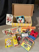 Photo showing all puzzles and games in collection with boxes and toys displayed on floor