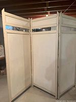 Full view of the 3-panel wooden room divider showing front side with glass strip near the top of each panel and white paint finish.