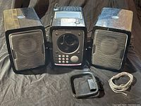 Front view of Philips stereo unit flanked by two detachable speakers, antenna and cable coiled on right side