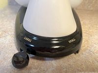 Close-up of mixer control dial showing 'Large' and 'Small' settings with black knob.