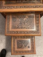 Overhead view of all four nested tables showing carved panels