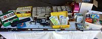Wide view of complete fishing gear lot laid out showing rods, reels, tackle boxes, and various fishing accessories.