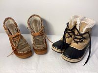 Two pairs of ladies winter boots displayed side by side, showing the front and top view of the Luxurious lace-up Yodelers and Sorel boots