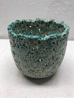 Front angled view showing glazing, textured and perforated pattern on bowl