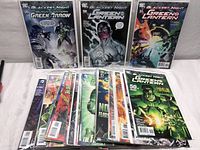 Three comic books prominently showing Blackest Night story arc featuring Green Lantern and Green Arrow with multiple other issues laid out below in protective sleeves.