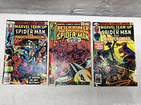 Front covers of 3 vintage Marvel comic books - Marvel Team-Up #64, Peter Parker The Spectacular Spider-Man #27, and Marvel Team-Up #89.
