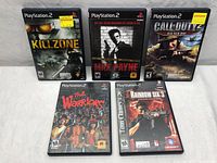 Full lot of five PlayStation 2 games arranged on a white surface.