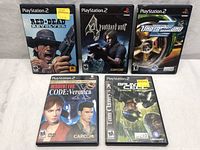 Lot of 5 PlayStation 2 game cases arranged on a white surface showing cover art of each title.