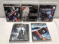 Lot of 5 PlayStation 3 game cases laid out showing front covers.