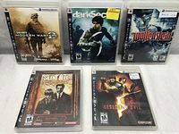 Photo of the five PlayStation 3 game cases: Call of Duty Modern Warfare 2, Dark Sector, Wolfenstein, Silent Hill Origins, Resident Evil 5 arranged in rows.