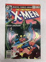 Front cover of The Uncanny X-Men #115 comic book with Sauron character.