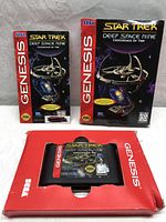 Front view of Sega Genesis game cartridge in red box and original game box and manual showing Star Trek Deep Space Nine artwork.