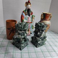 View of the lot showing all items with focus on foo dogs and figurine, background is plain
