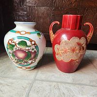 Photo showing both vases side by side on floor, highlighting their size and colors.