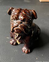 Front view of the ceramic John Bull Dog bank showing detailed dog face and collar with metal loop.
