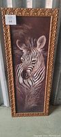 Full view of the framed zebra painting, showing the ornate gold frame and detailed artwork.