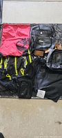 Overview of all backpacks and bags included in the lot arranged on the floor
