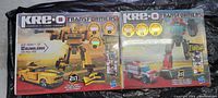 Photo of two Kre-O Transformers 2-in-1 building sets featuring Autobot Bumblebee and Autobot Ratchet in boxes.
