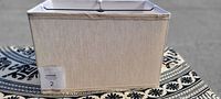 Front and top angled view of the off-white rectangular lampshade showing fabric texture and structure.