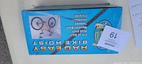 Box front view showing Rad Easy Bike Hoist, suitable for various bicycle types including road, mountain, and tricycles.
