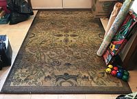 Top view of the Korhani Renaissance Collection synthetic area rug showing the floral and ornamental patterned design and dark border.