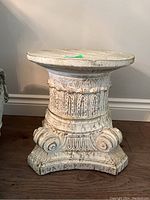 Front and side views of composite column stand in distressed white finish with classical carved details and scroll base
