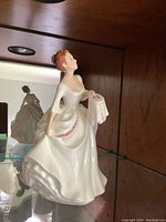 Royal Doulton figurine "Carol" HN2961 in white and pink dress.