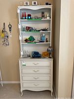 Front view of white Baronet dresser with attached shelf unit and items on shelves