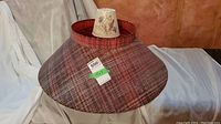 Large red plaid fiberglass lamp shade shown from front and side angles